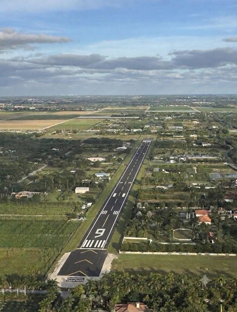 Illustrative aerial view of a paved private runway in a residential setting
